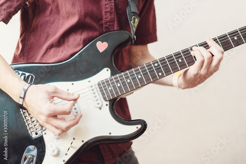 Man's finger touched the guitar line to play songs, solo of music instrument of vintage light showMan's finger touched the guitar line to play songs, solo of music instrument of vintage light show