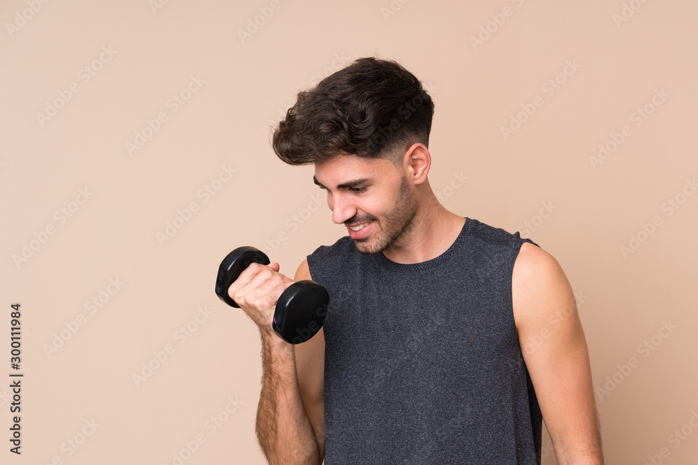 Young sport man over isolated background making weightlifting Young sport man over isolated background making weightlifting