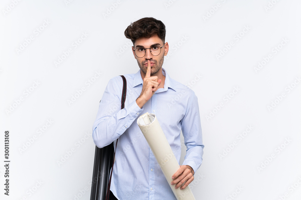 Young architect man over isolated white background doing silence gesture Young architect man over isolated white background doing silence gesture