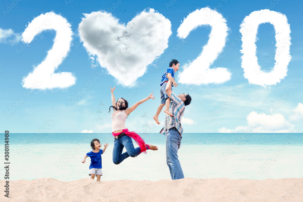 Asian family with number 2020 on beach Asian family with number 2020 on beach