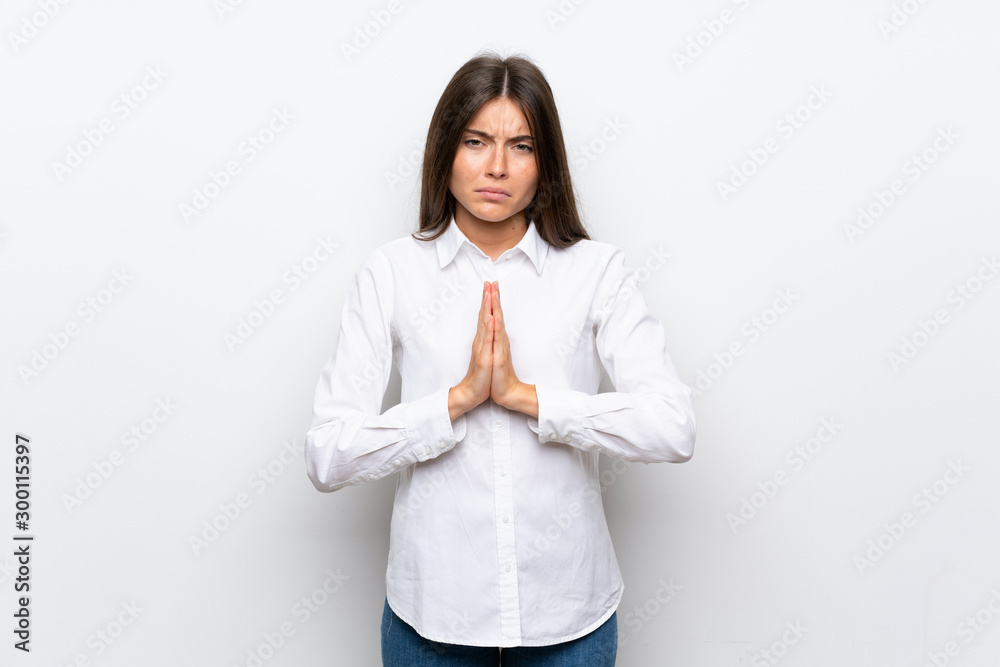 Young woman over isolated white background pleading Young woman over isolated white background pleading