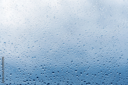 Raindrops on window glass surface, background texture