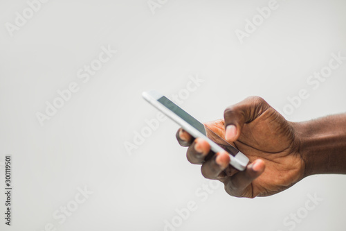 smartphone in the hand of an adult african man