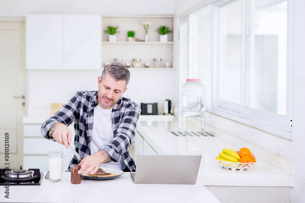 Caucasian man makes chocolate bread while works Caucasian man makes chocolate bread while works