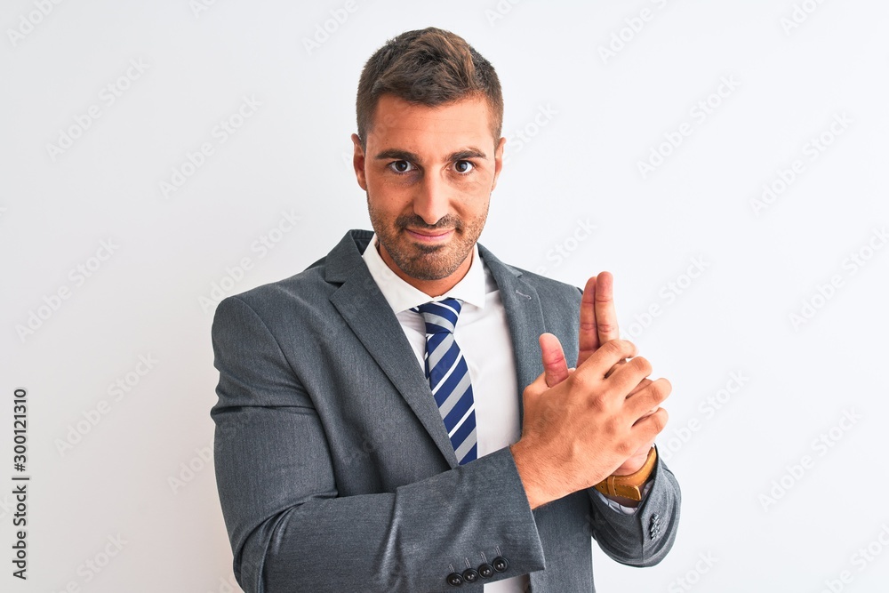 Young handsome business man wearing suit and tie over isolated background Holding symbolic gun with hand gesture, playing killing shooting weapons, angry face Young handsome business man wearing suit and tie over isolated background Holding symbolic gun with hand gesture, playing killing shooting weapons, angry face