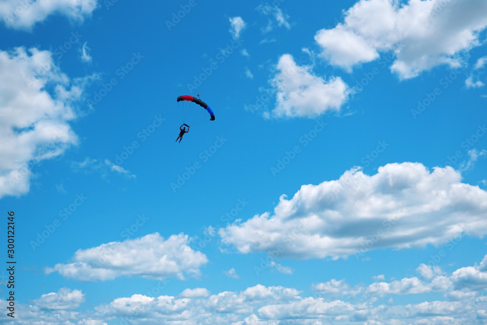 Skydiver with a black red blue canopy Skydiver with a black red blue canopy
