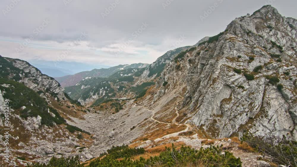 Beautiful view of rocky path hiking trail in Julian Alps. Colorful autumn mountain range. Travel Vacation Nature Beauty Concept. Beautiful view of rocky path hiking trail in Julian Alps. Colorful autumn mountain range. Travel Vacation Nature Beauty Concept.