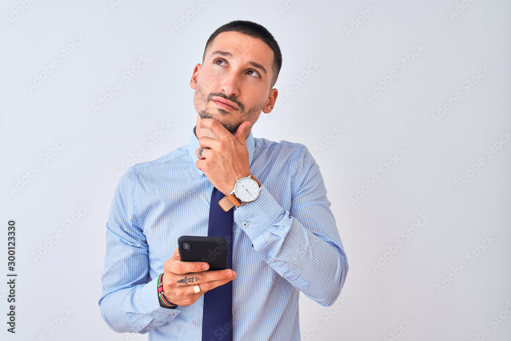 Young handsome business man using smartphone over isolated background serious face thinking about question, very confused idea