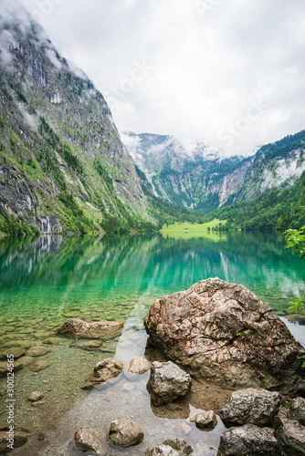 View of the upper Obersee lake, near Koenigsee. Bavaria. In the background the highest waterfall of Germany - Rothbachfall.
