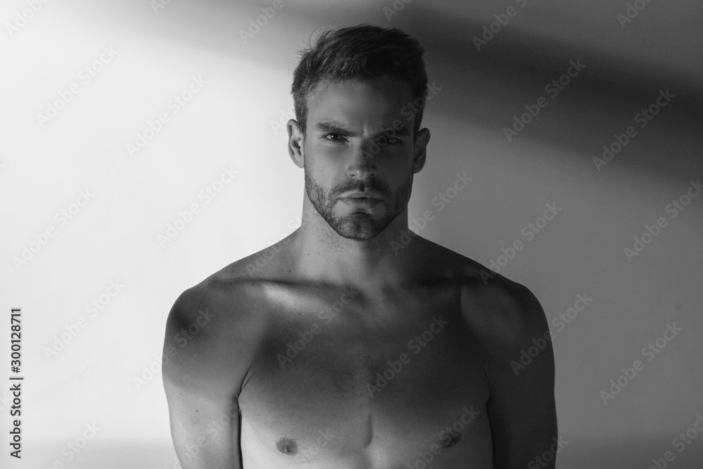 Black and White Strong stripped muscle male model in white underwear on white isolated font background with shadows