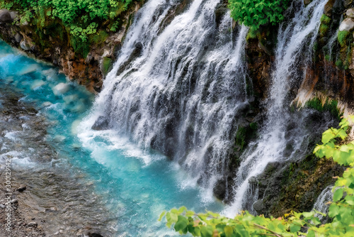 Fototapeta Naklejka Na Ścianę i Meble -  Scenery of shirahige's waterfall and Biei river. The water of this river flows into the blue pond at the downstream. Biei Hokkaido, Japan