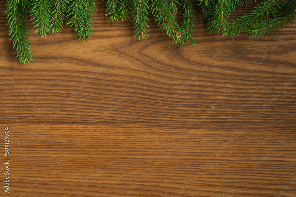 Flat lay christmas background with spruce twigs on ash wood surface Flat lay christmas background with spruce twigs on ash wood surface