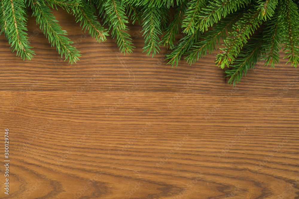 Flat lay christmas background with spruce twigs on ash wood surface Flat lay christmas background with spruce twigs on ash wood surface