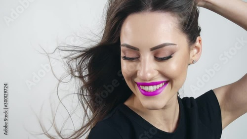 Happy smiling woman dressed in black t-shirt with purple lips, 100 FPS slowmotion