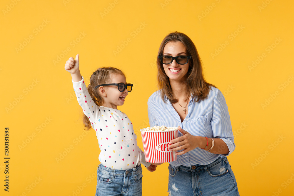 Woman have fun with child baby girl 4-5 years old. Mommy little kid daughter in 3d glasses watch movie film isolated on yellow background studio portrait. Day love family parenthood childhood concept. Woman have fun with child baby girl 4-5 years old. Mommy little kid daughter in 3d glasses watch movie film isolated on yellow background studio portrait. Day love family parenthood childhood concept.