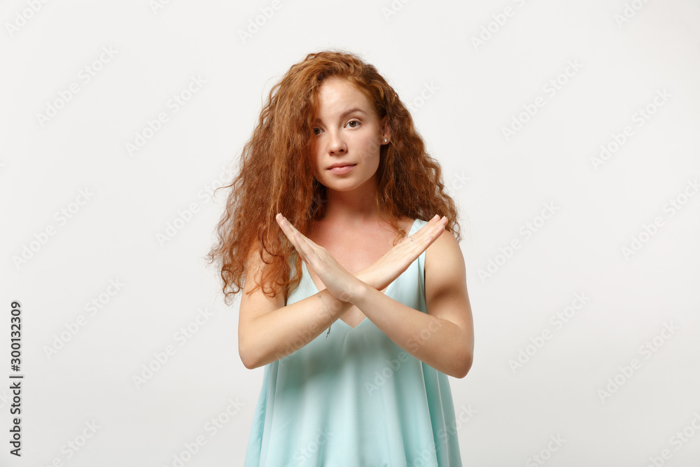 Young redhead woman girl in casual light clothes posing isolated on white wall background, studio portrait. People lifestyle concept. Mock up copy space. Showing stop gesture with crossed hands.