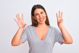 Portrait of beautiful young woman standing over isolated white background showing and pointing up with fingers number eight while smiling confident and happy.