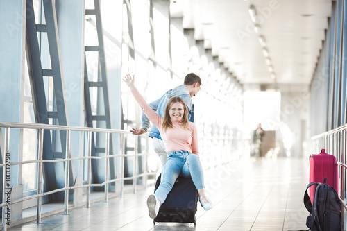 Couple traveling. Lovers journey. Young man and woman in the airport. Family tour.