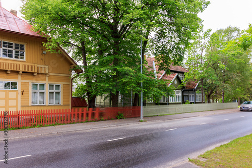 Typical old architecture of city Parnu, Estonia. empty narrow streets of historic center town Parnu. Medieval small wooden houses on Kuninga street. historical center of Parnu.  photo