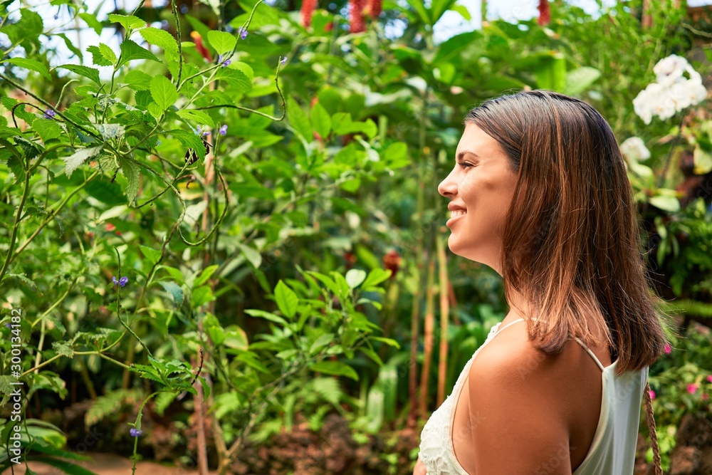 Young beatiful woman smiling happy and cheerful at butterfly garden on a sunny day of summer Young beatiful woman smiling happy and cheerful at butterfly garden on a sunny day of summer
