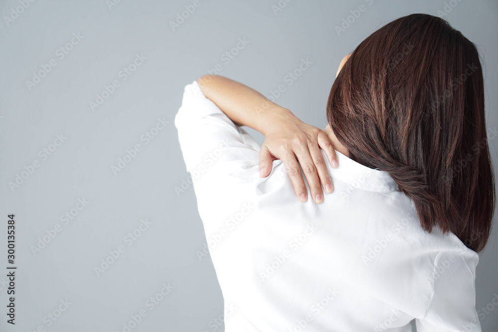 Closeup woman holding neck with pain, healthy care and medical concept Closeup woman holding neck with pain, healthy care and medical concept