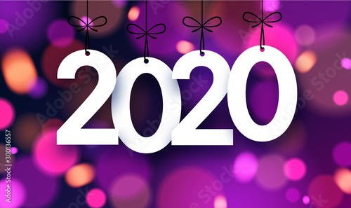 Bright blurred 2020 New Year card with color lights.