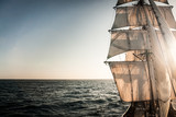 Backlit sails of a traditional tall ship on the atlantic