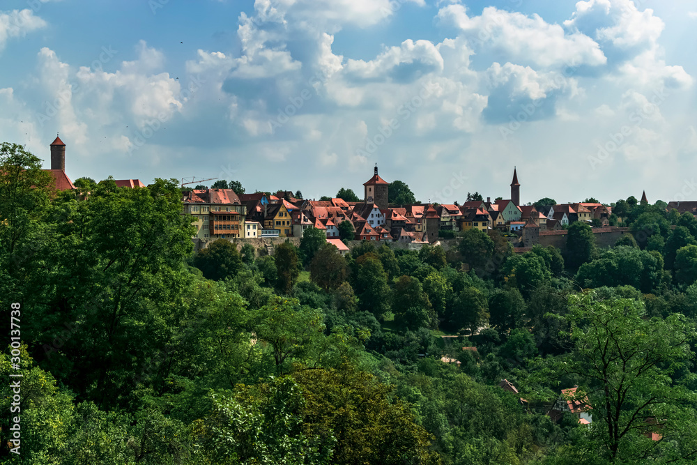 Panoramic of a small town with red roofs, with the silhouette of its towers. Photograph taken in Rothenburg ob der Tauber, Bavaria, Germany