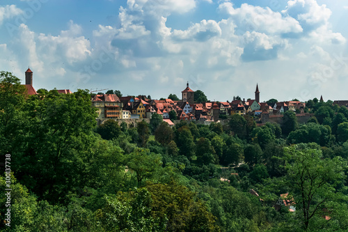 Panoramic of a small town with red roofs, with the silhouette of its towers. Photograph taken in Rothenburg ob der Tauber, Bavaria, Germany