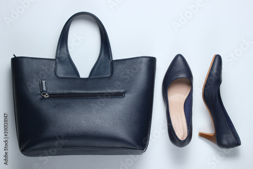 Classic high heel shoes, leather bag on white background. Minimalism fashion concept. Top view