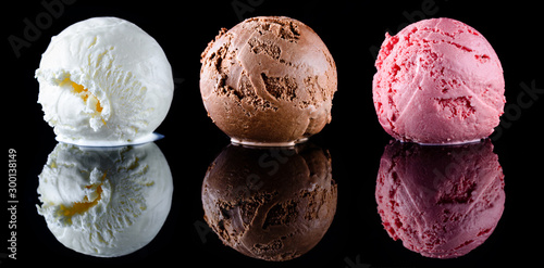 Fotografie Strawberry ice cream, vanilla ice cream and chocolate ice cream scoops