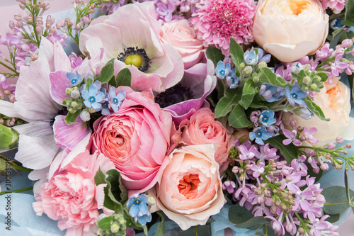 Beautiful elegant soft wedding pink blue bouquet with roses and lilac flowers. Floral background