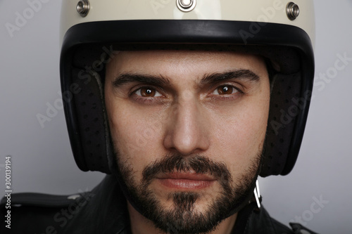 Close up portrait of young and handsome biker looking at the camera.