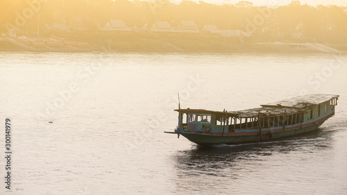 A boat carrying goods sailing on the Mekong River