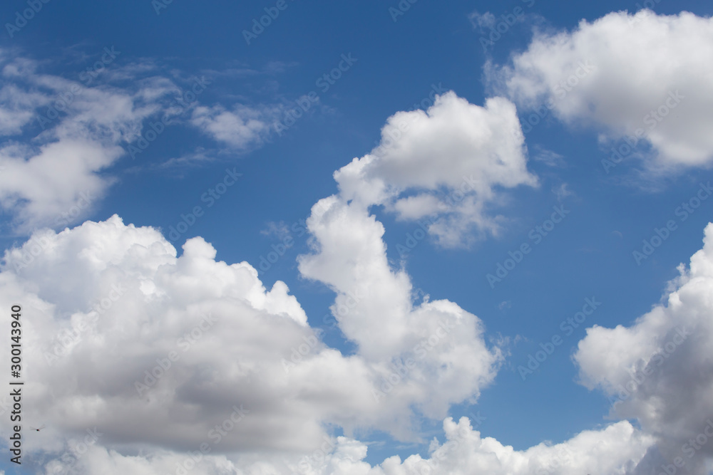 Clouds in the blue sky. White fluffy clouds in the blue sky. Clouds in the blue sky. White fluffy clouds in the blue sky.
