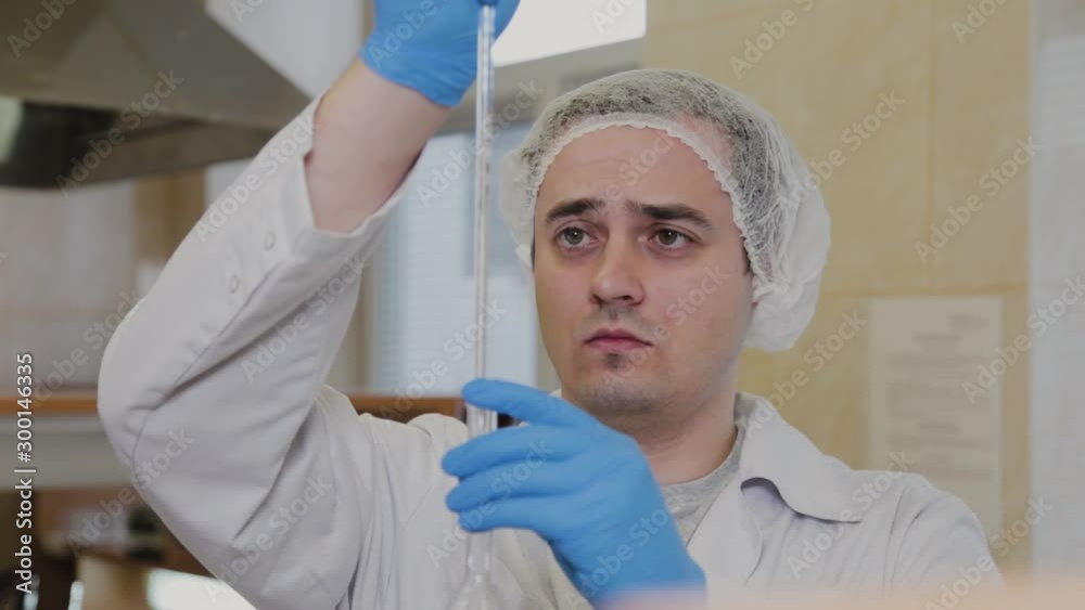 Male scientist with test tubes in a laboratory conducts an experiment. Male scientist with test tubes in a laboratory conducts an experiment.