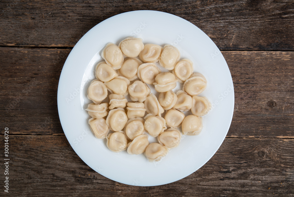 boiled dumplings in a plate on a wooden table boiled dumplings in a plate on a wooden table
