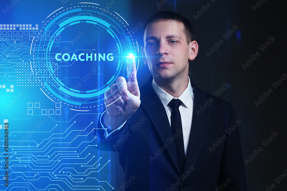 Business, Technology, Internet and network concept. Young businessman working on a virtual screen of the future and sees the inscription: Coaching Business, Technology, Internet and network concept. Young businessman working on a virtual screen of the future and sees the inscription: Coaching