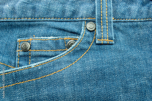 Close up of Blue jeans,Detail of vintage jeans texture with pocket studs and stitch with selective focus.