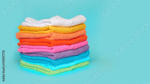 stack of multi-colored clean towels on a blue background