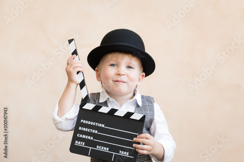 Funny kid holding clapper board © Sunny studio
