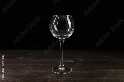Photo of an empty wine glass. Nice color on a black background.