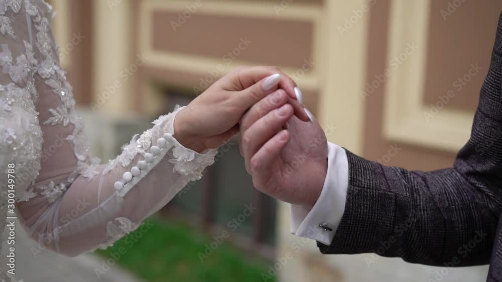 Wedding couple in a city. Bride and groom holding hands. Wedding couple in a city. Bride and groom holding hands.