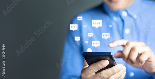 Live chat chatting and social network concepts, Close-up hands using mobile smartphone with chat box icons photo