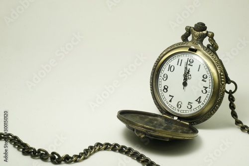 Old pocket watch on white background.