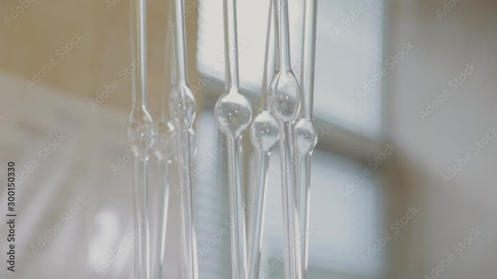 Glass test tubes in a science laboratory. Glass test tubes in a science laboratory.