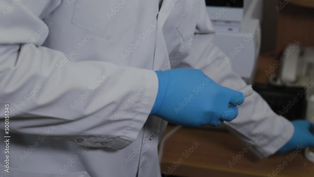 Scientist opens a syringe for an experiment. Scientist opens a syringe for an experiment.