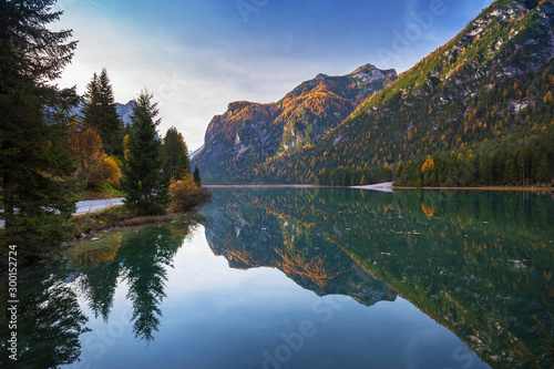 Dolomites mountains with reflection in Lago di Dobbiaca lake at autumn. Italy