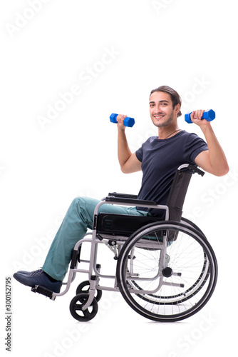 Young disabled man doing physical exercises isolated on white