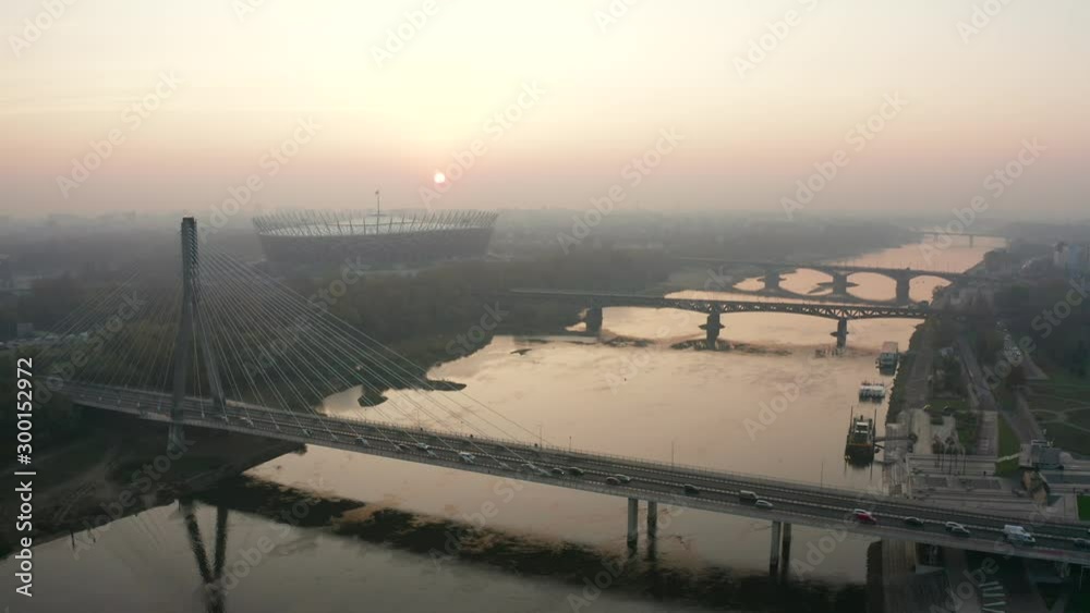 Aerial view of a beautiful landscape with bridges and the Vistula River in Warsaw, Poland. Drone shot on a river with bridges in the fog at sunrise. Aerial view of a beautiful landscape with bridges and the Vistula River in Warsaw, Poland. Drone shot on a river with bridges in the fog at sunrise.